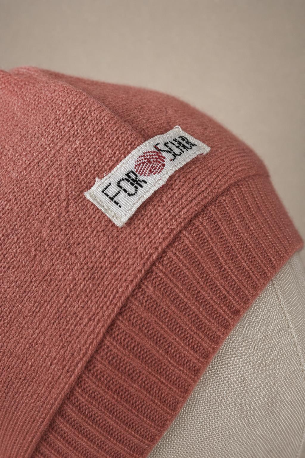 Detailaufnahme des Kaschmir Kapuzenschals in Rosa