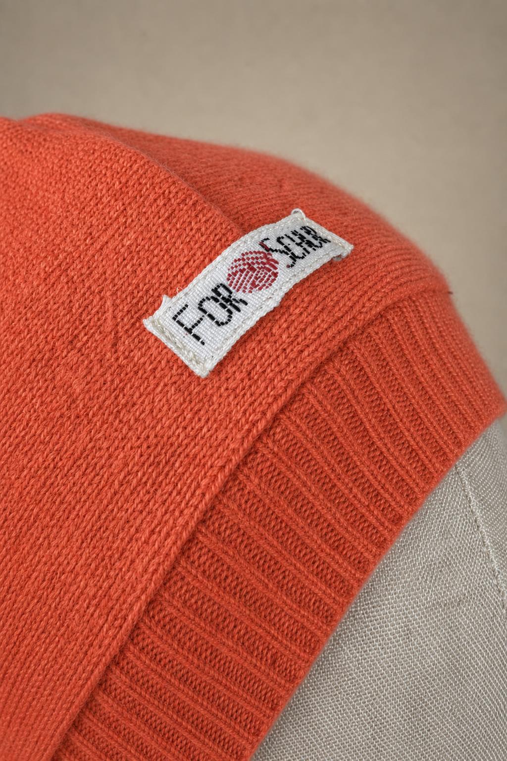 Detailaufnahme des Kaschmir Kapuzenschals in Pink