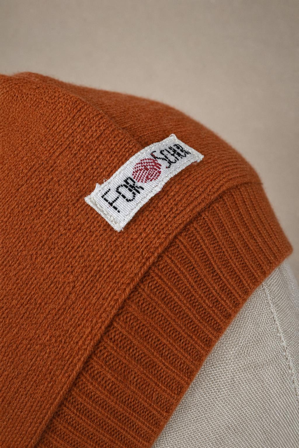 Detailaufnahme des Kaschmir Kapuzenschals in Orange