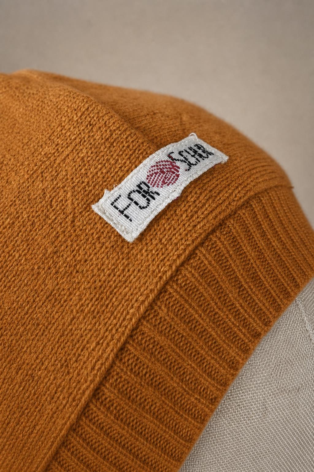 Detailaufnahme des Kaschmir Kapuzenschals in Orange