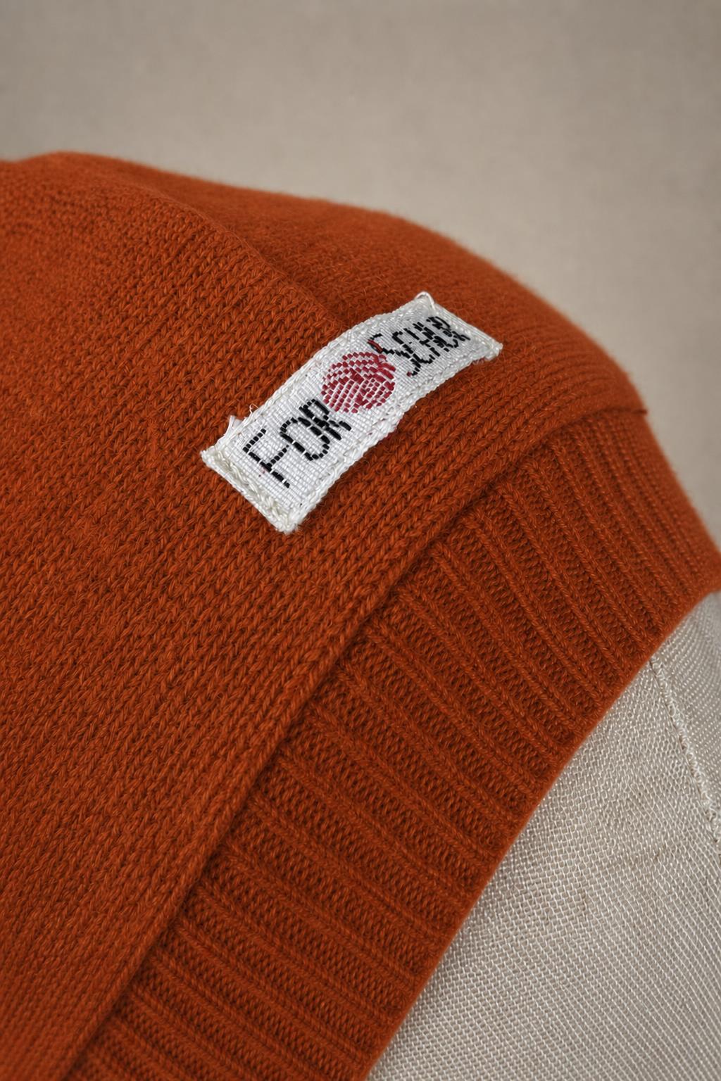 Detailaufnahme des Kaschmir Kapuzenschals in Orange