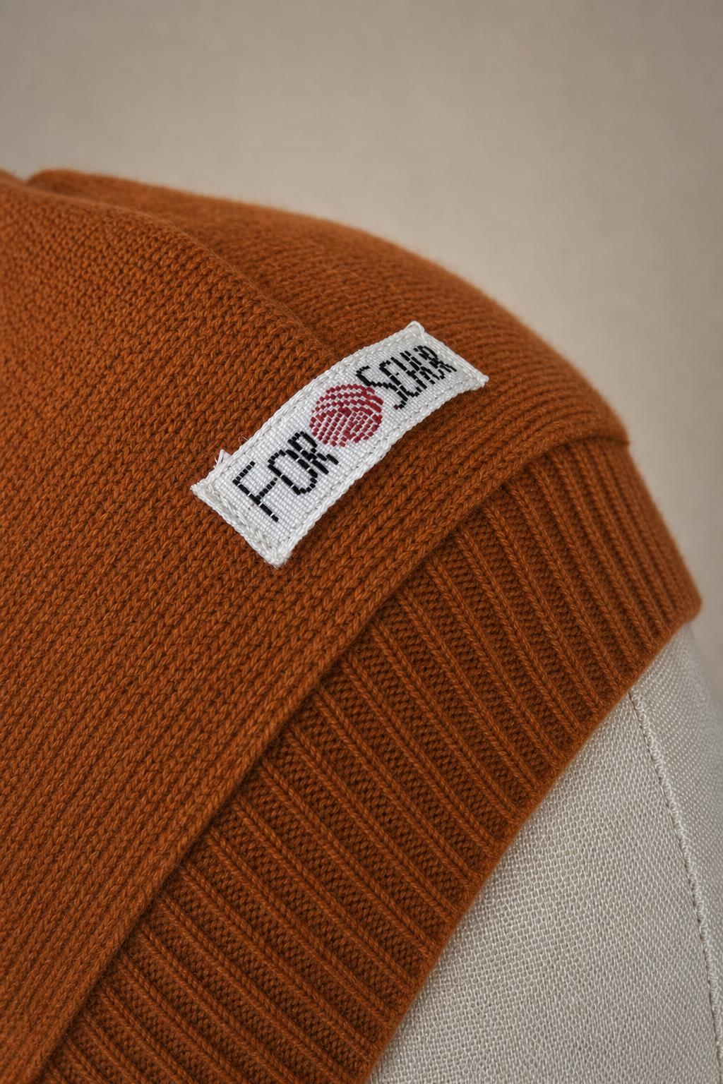 Detailaufnahme des Kaschmir Kapuzenschals in Orange
